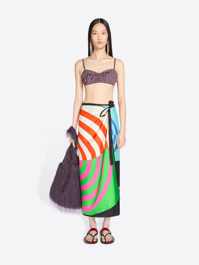 Model wearing a colorful skirt and top on a white background - Dries Van Noten