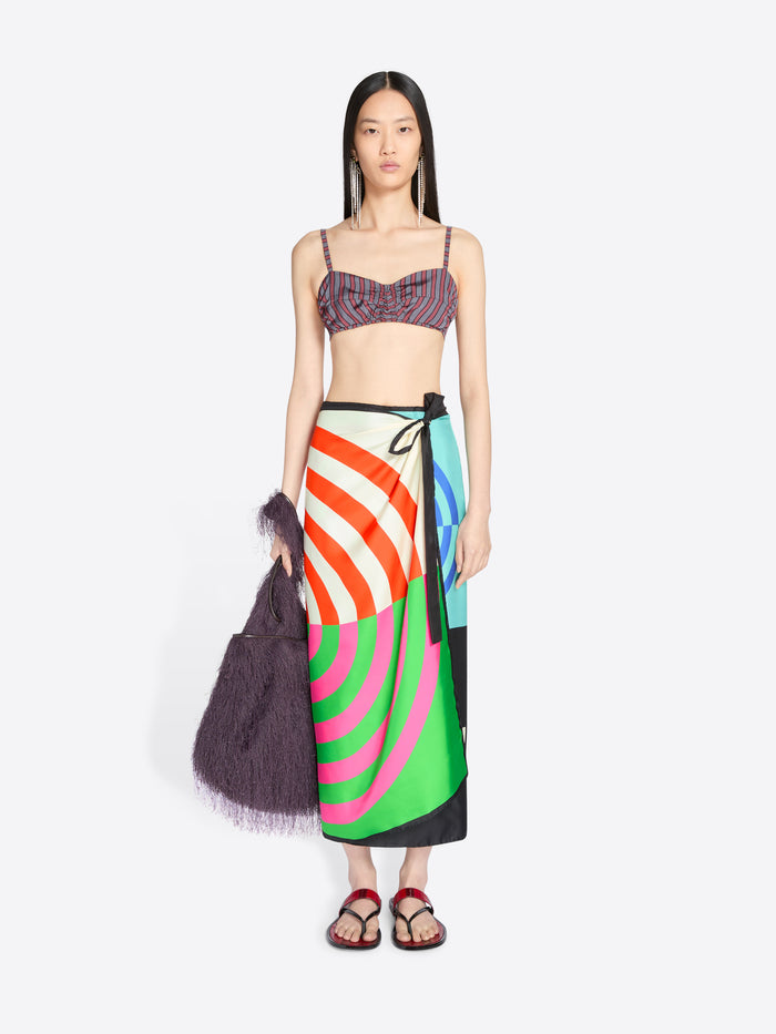 Model wearing a colorful skirt and top on a white background - Dries Van Noten
