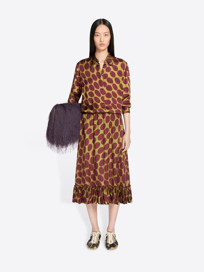 Woman wearing a patterned dress holding a purple bag on a white background - Dries Van Noten