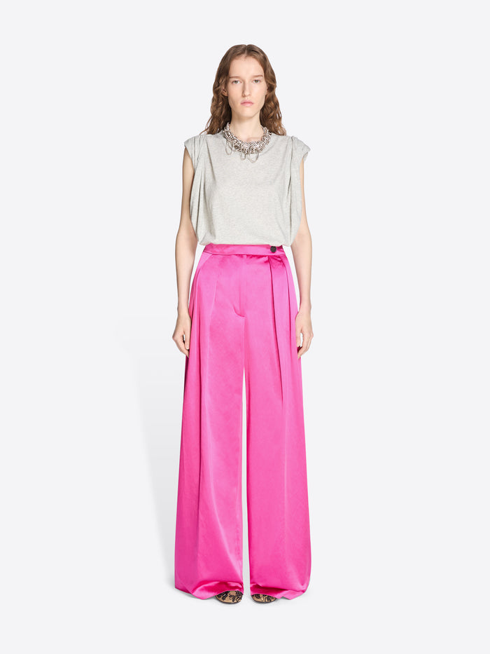 Woman wearing a light gray sleeveless top and bright pink wide-leg pants on a white background - Dries Van Noten
