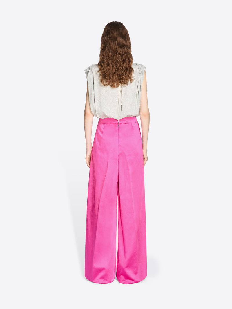 Person wearing a white top and bright pink pants on a white background - Dries Van Noten