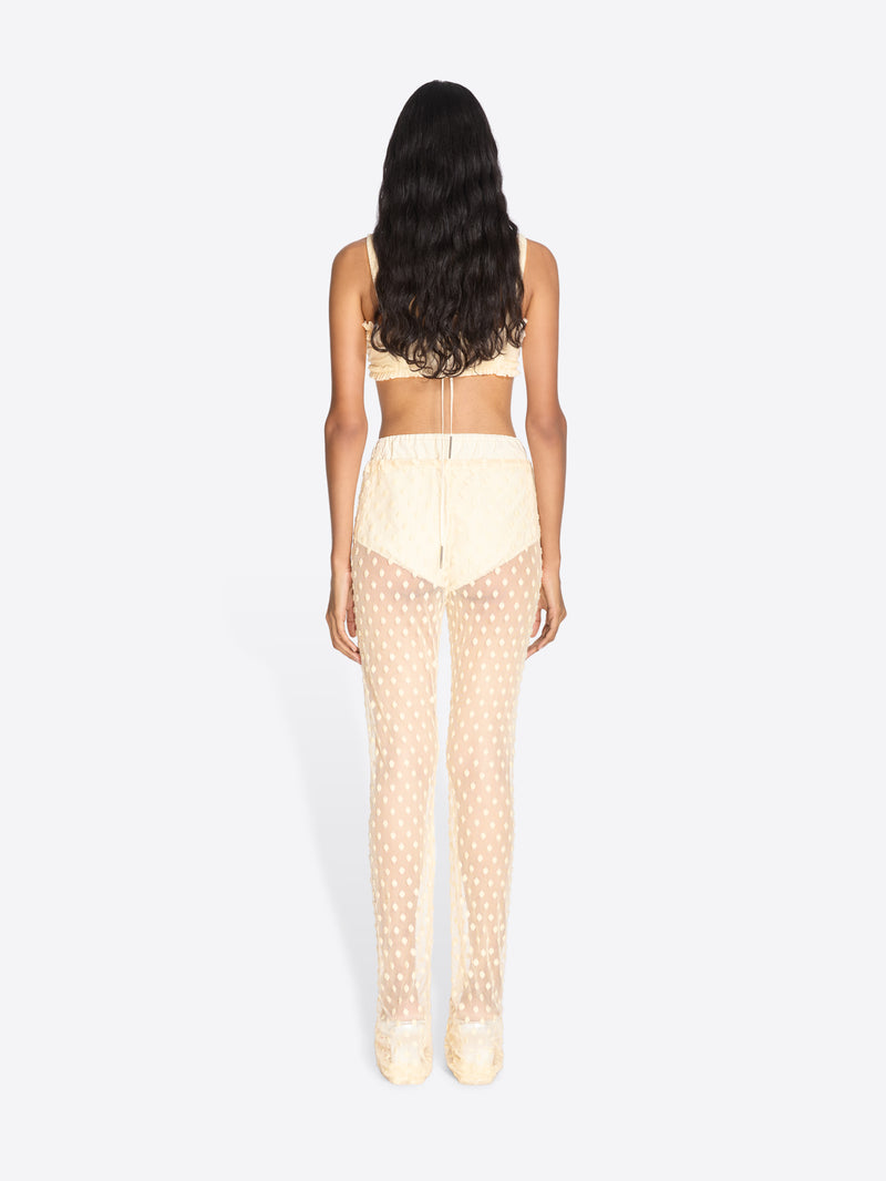 Woman wearing a beige polka dot outfit on a white background - Dries Van Noten