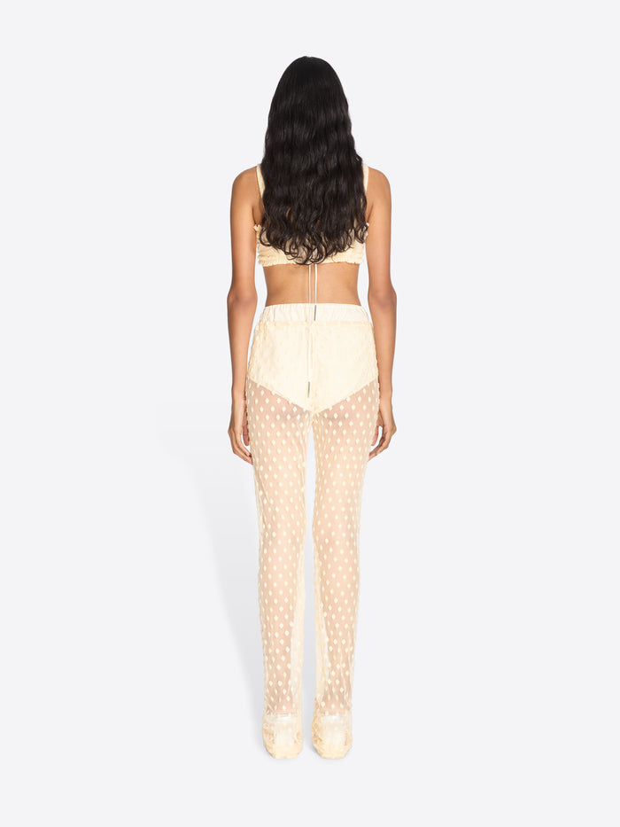 Woman wearing a beige polka dot outfit on a white background - Dries Van Noten