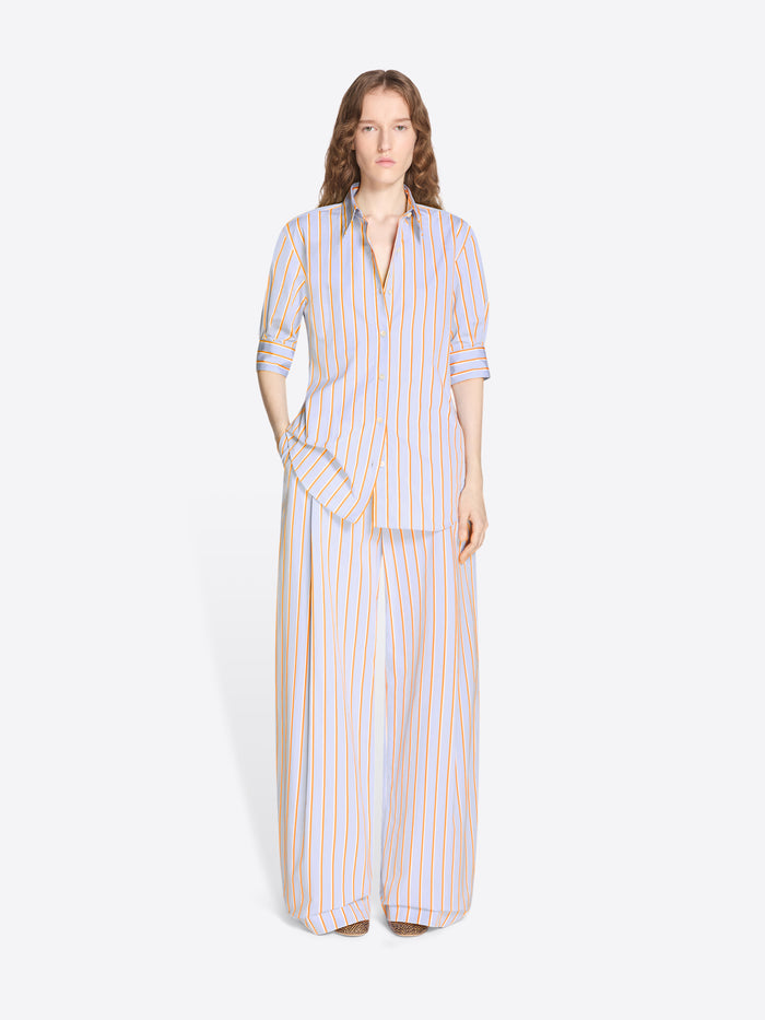 Woman wearing a striped shirt and long pants on a white background - Dries Van Noten