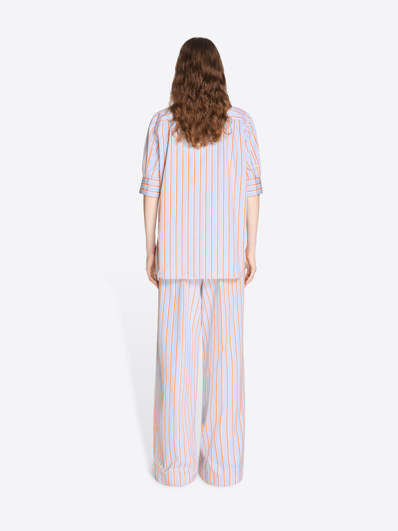 Woman wearing a striped pajama set on a white background - Dries Van Noten