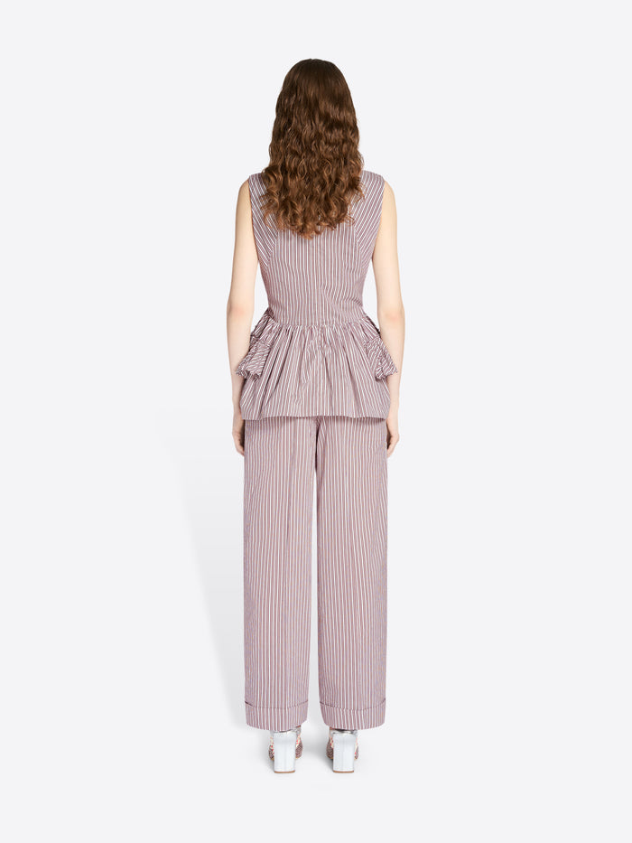 Woman wearing a matching set of sleeveless top and wide-leg pants with a peplum waist on a white background - Dries Van Noten