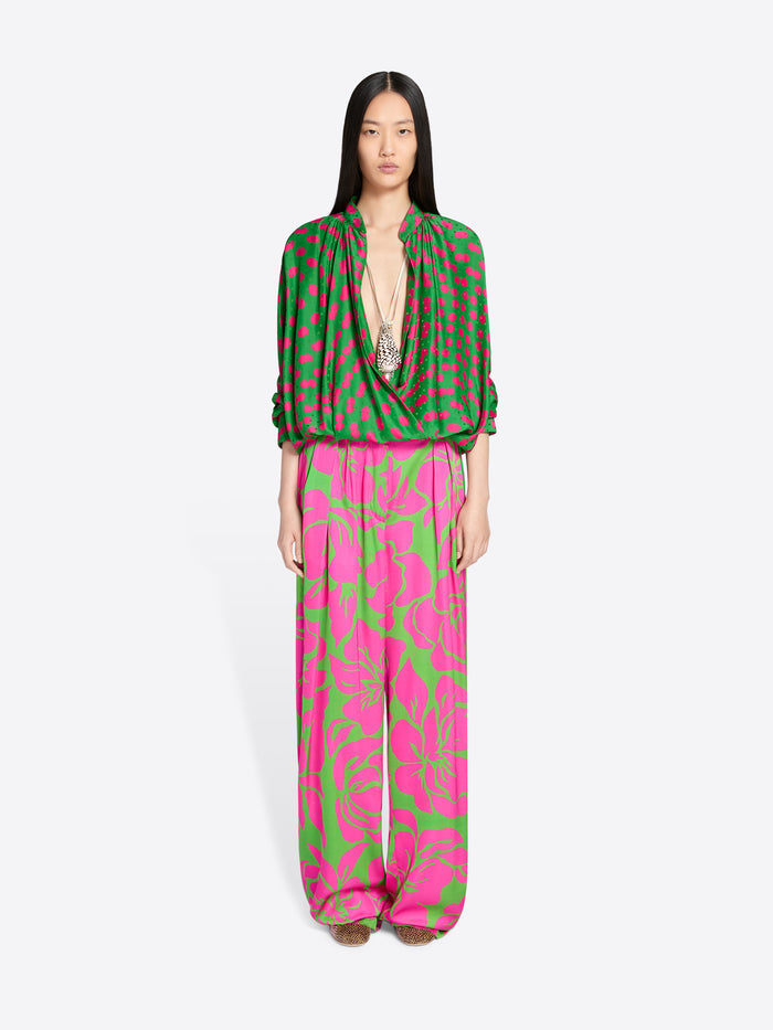 Model wearing a green and pink patterned outfit on a white background - Dries Van Noten
