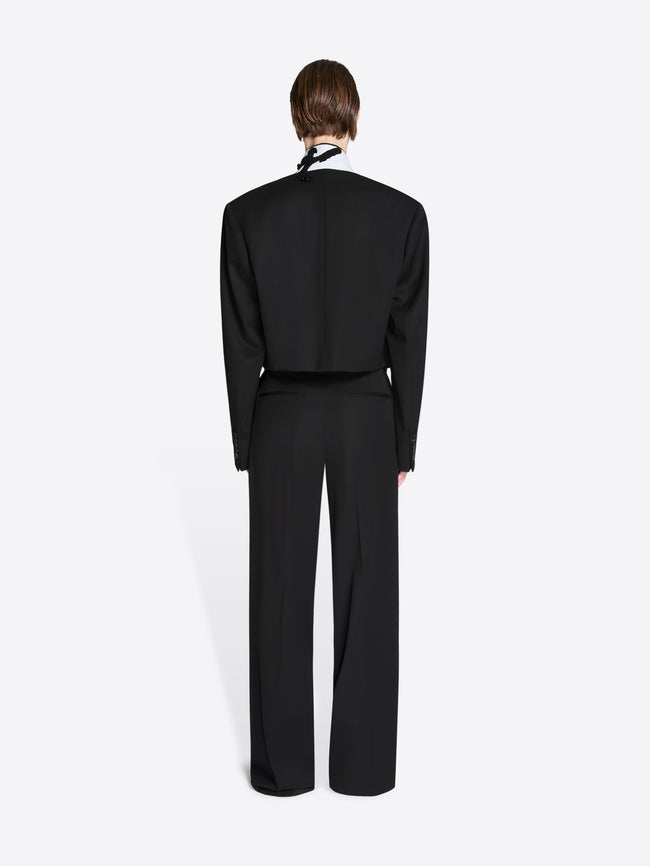Person wearing a black suit on a white background - Dries Van Noten