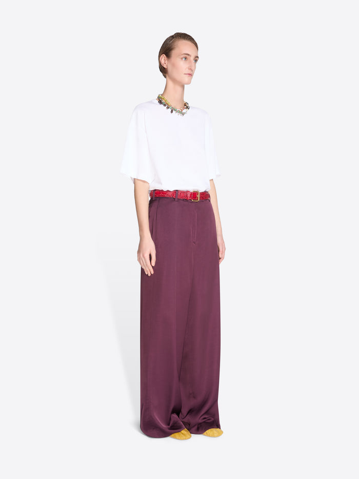 Person wearing a white top and long purple skirt on a white background - Dries Van Noten