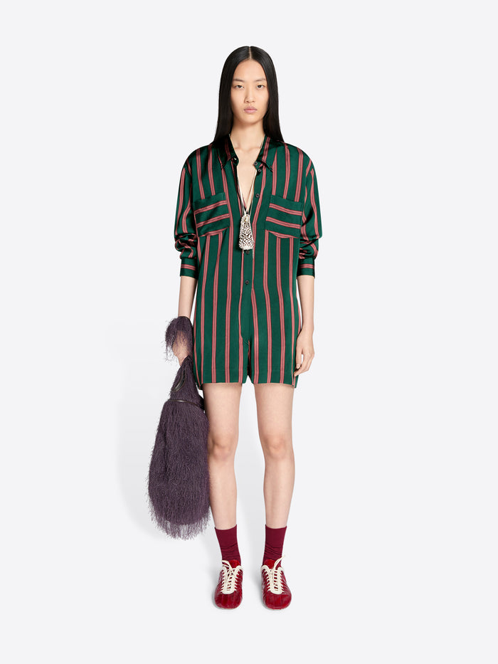 Woman wearing a green and red striped jumpsuit with a white background - Dries Van Noten