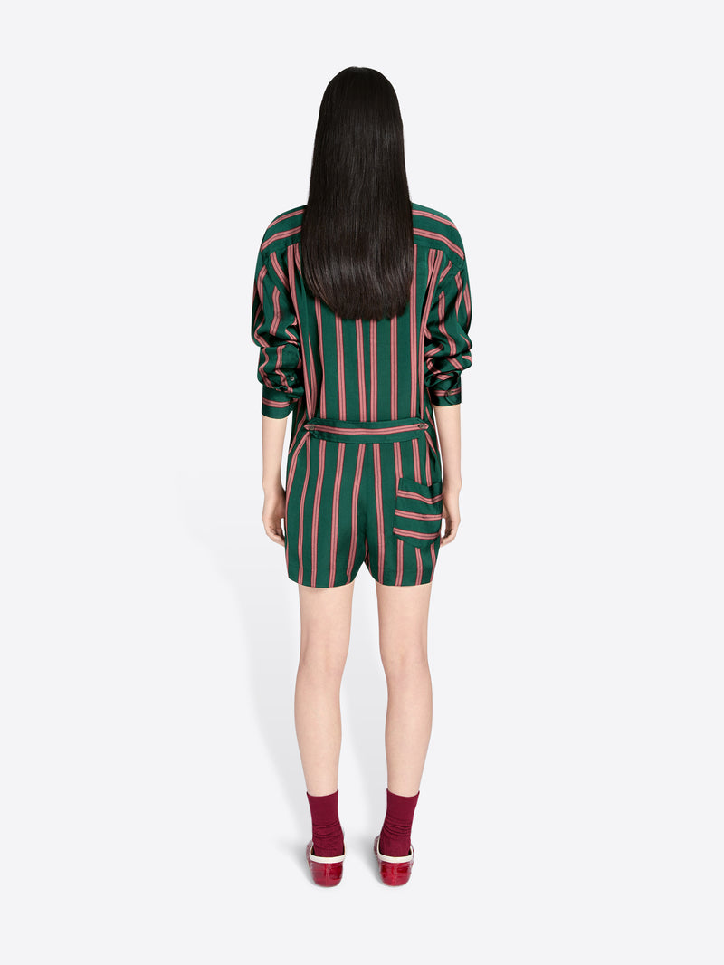 Person wearing a green and pink striped outfit on a white background - Dries Van Noten