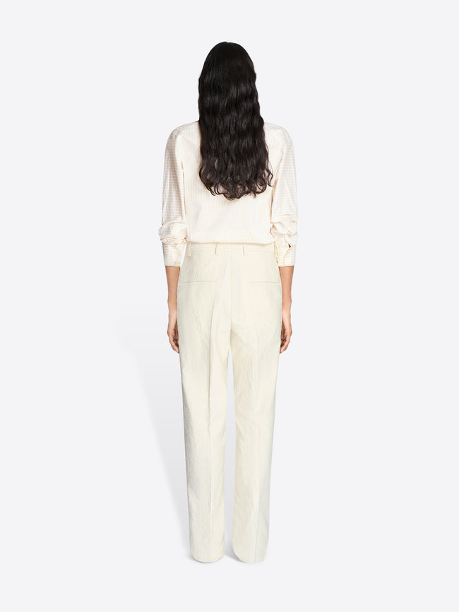Person wearing a white outfit on a plain background - Dries Van Noten