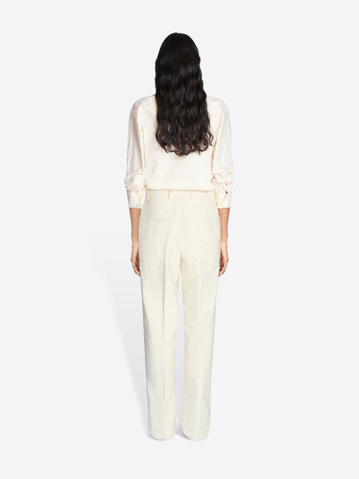 Person wearing a white outfit on a plain background - Dries Van Noten