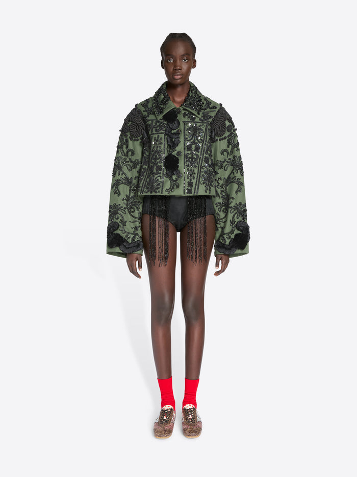 Model wearing a patterned green jacket on a white background - Dries Van Noten