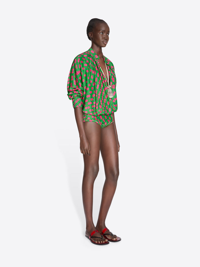 Model wearing a green and red patterned outfit on a white background - Dries Van Noten