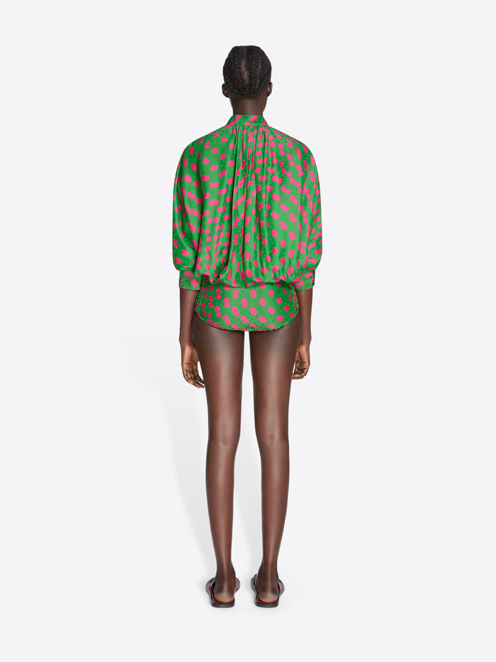 Person wearing a green and red polka dot blouse on a white background - Dries Van Noten