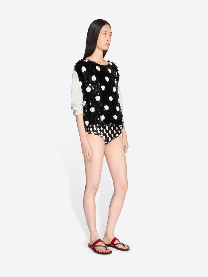 Model wearing a black and white polka dot outfit on a white background - Dries Van Noten