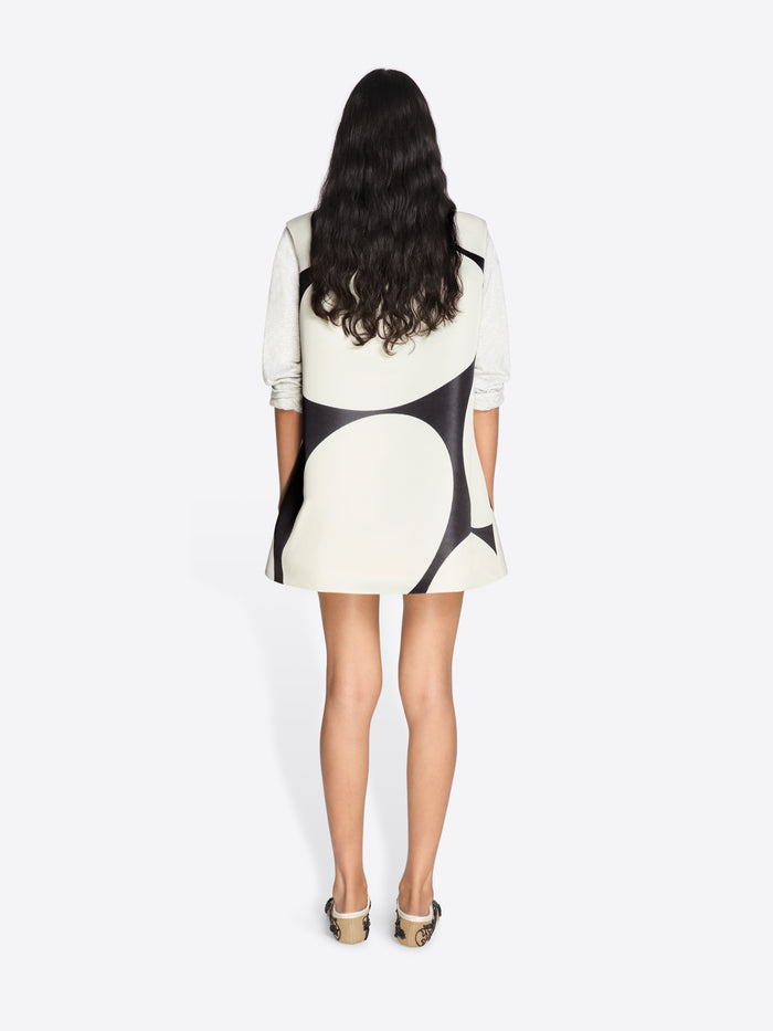 Woman wearing a black and white dress with abstract pattern on a white background - Dries Van Noten