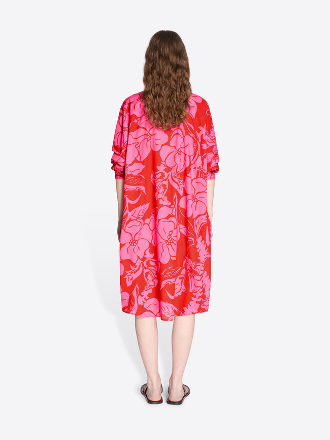 Person wearing a red and pink floral dress on a white background - Dries Van Noten