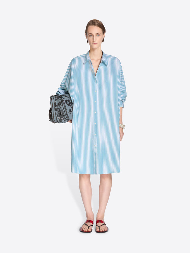 Woman wearing a blue shirt dress on a white background. - Dries Van Noten