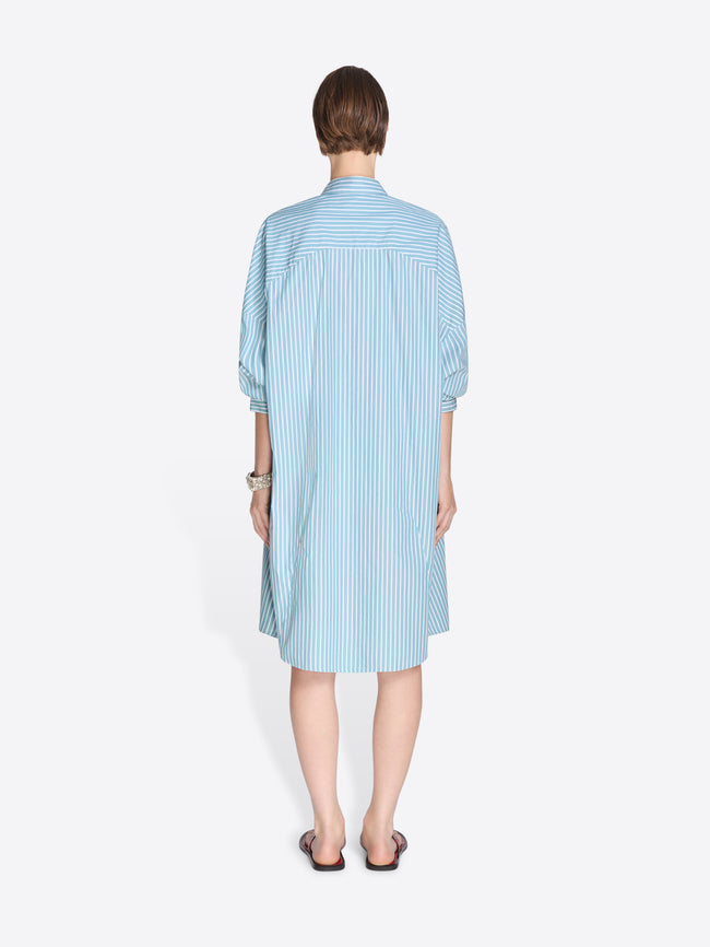 Woman wearing a blue shirt dress on a white background. - Dries Van Noten
