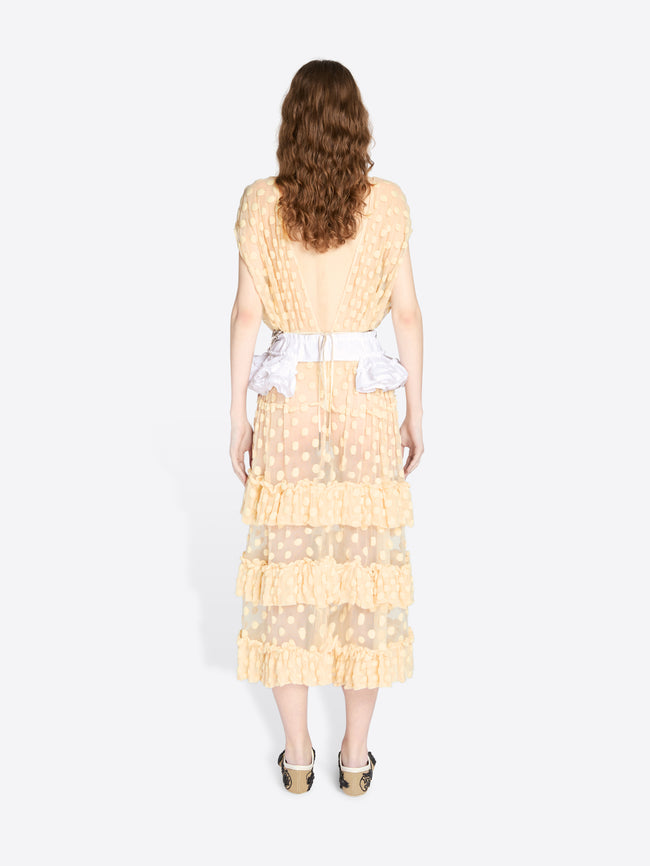 Woman wearing a light yellow dress with ruffled layers on a white background - Dries Van Noten