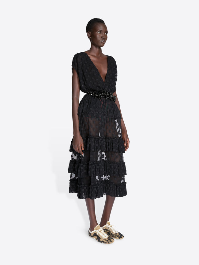 Woman wearing a black lace dress on a white background - Dries Van Noten