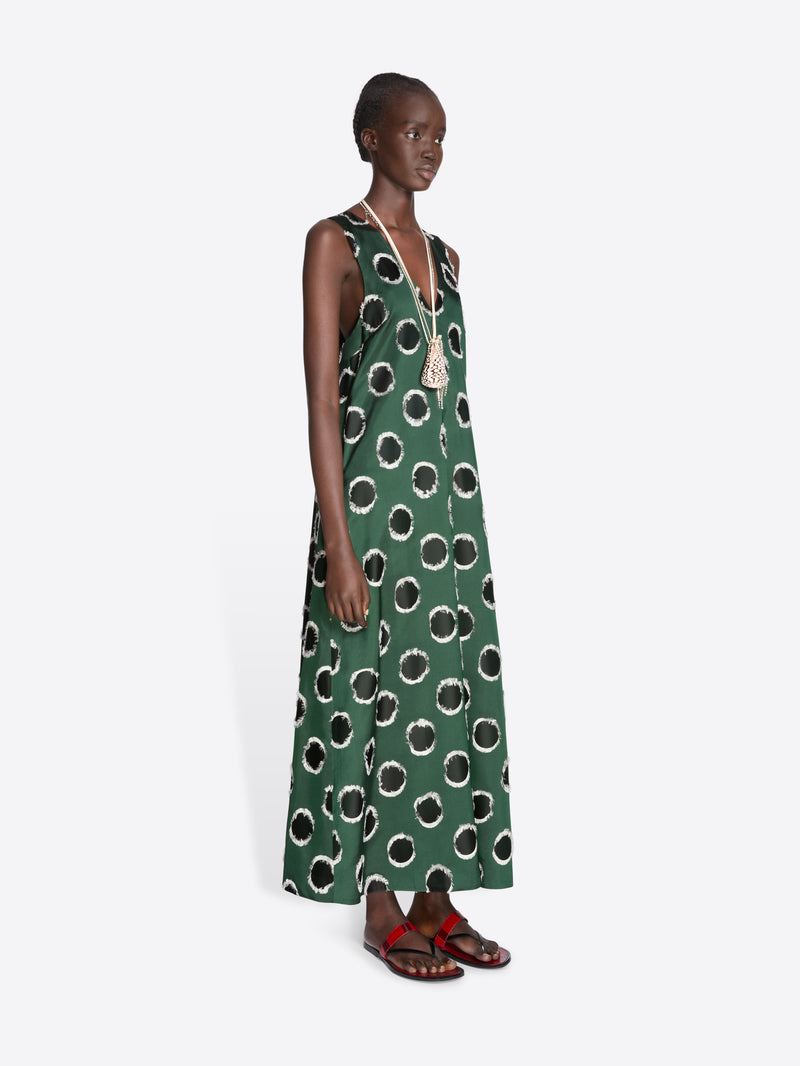 Model wearing a green dress with black abstract patterns on a white background - Dries Van Noten
