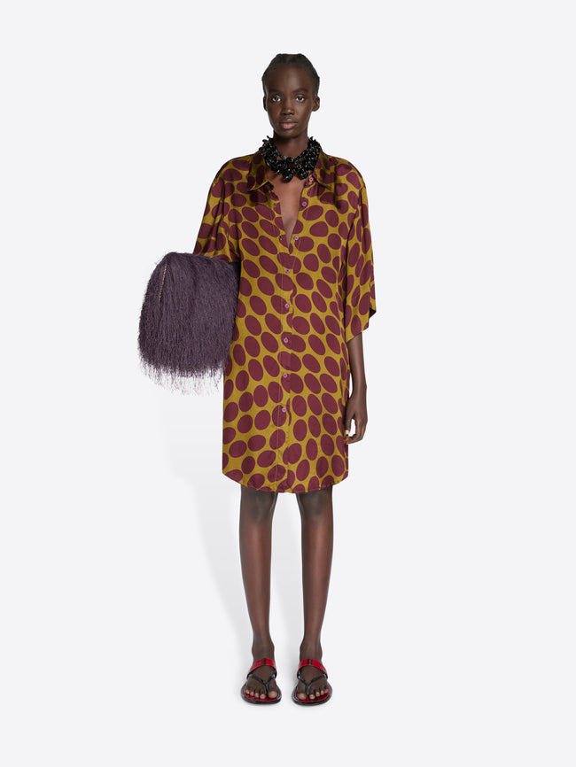 Model wearing a patterned dress with a purple bag on a white background - Dries Van Noten