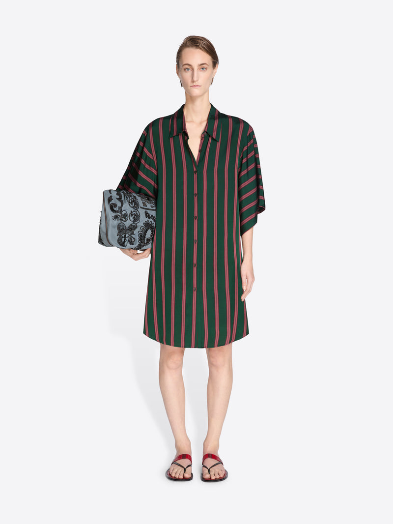 Woman wearing a green and red striped dress holding a black clutch against a white background - Dries Van Noten