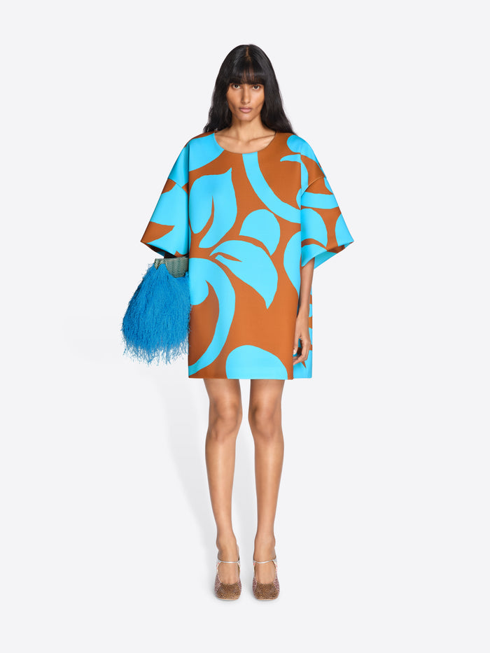 Woman wearing a blue and brown patterned dress with a white background - Dries Van Noten