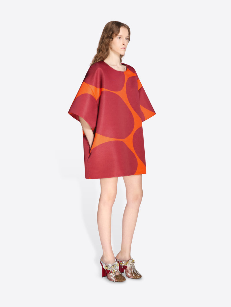 Model wearing a red and orange patterned dress on a white background - Dries Van Noten