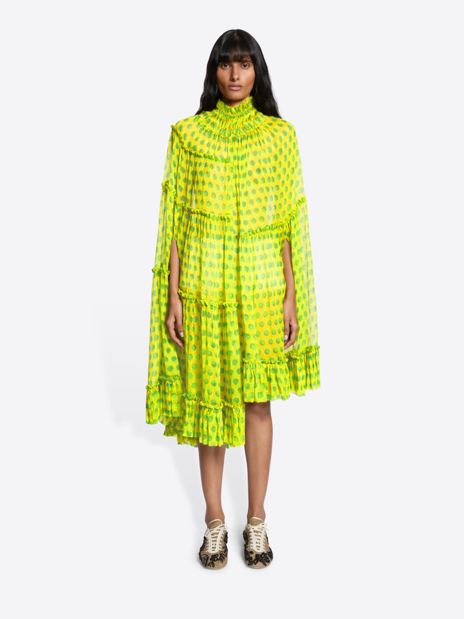 Woman wearing a bright yellow dress with a subtle pattern on a white background - Dries Van Noten
