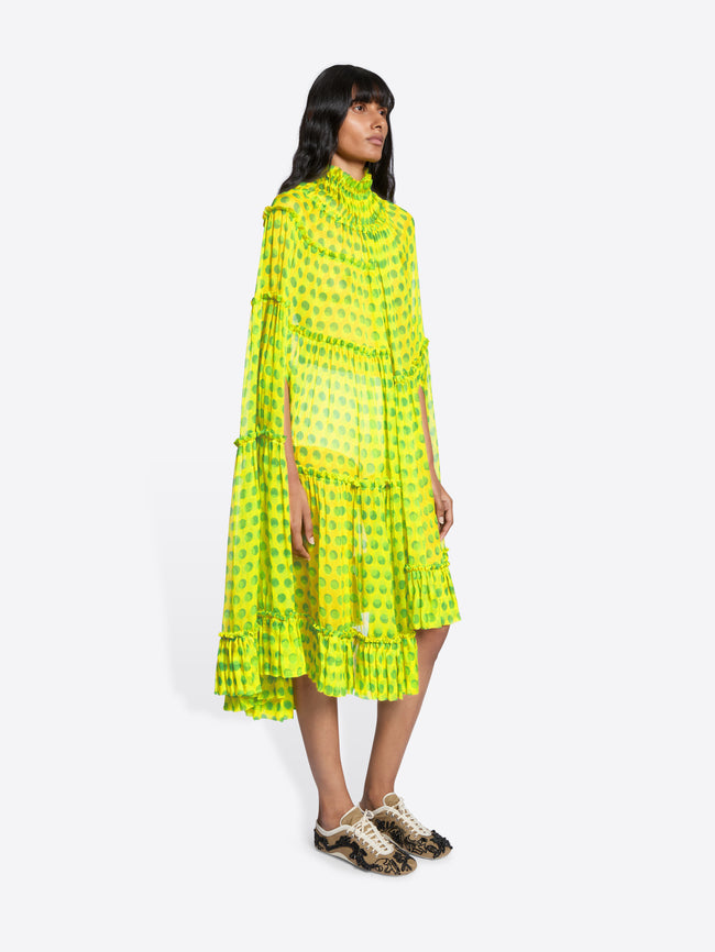 Woman wearing a bright yellow dress with a pattern on a white background - Dries Van Noten