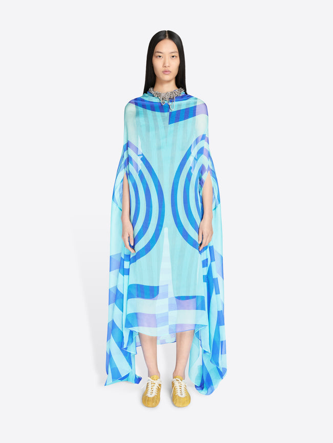 Woman wearing a blue and light blue patterned dress on a white background - Dries Van Noten