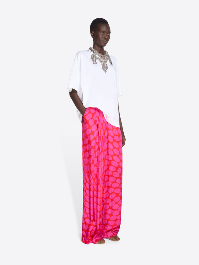 Woman wearing a white top and pink patterned skirt on a white background - Dries Van Noten