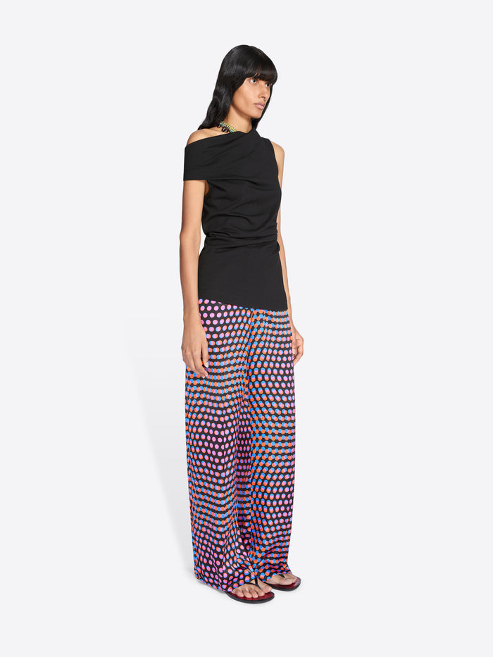 Woman wearing a black top and patterned pants on a white background - Dries Van Noten