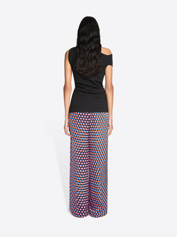Woman wearing a black top and patterned pants on a white background - Dries Van Noten