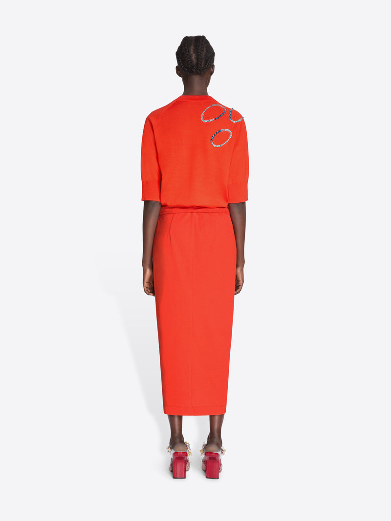 Person wearing an orange outfit with a white background - Dries Van Noten