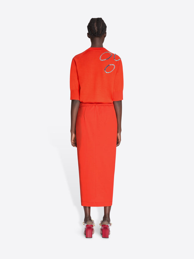 Person wearing an orange outfit with a white background - Dries Van Noten