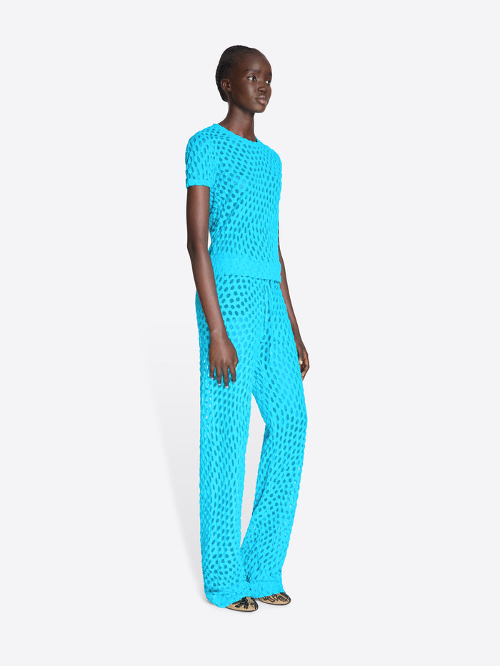 Woman wearing a bright blue textured outfit on a white background - Dries Van Noten