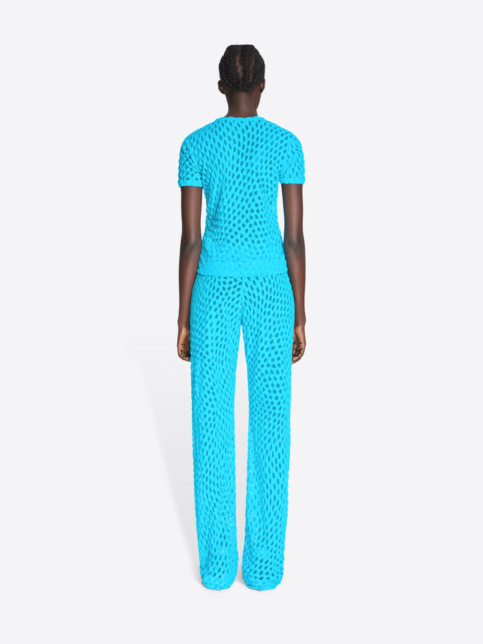Person wearing a bright blue jumpsuit on a white background - Dries Van Noten