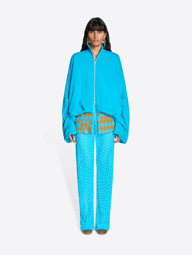 Woman wearing a blue tracksuit with a pattern on a white background - Dries Van Noten