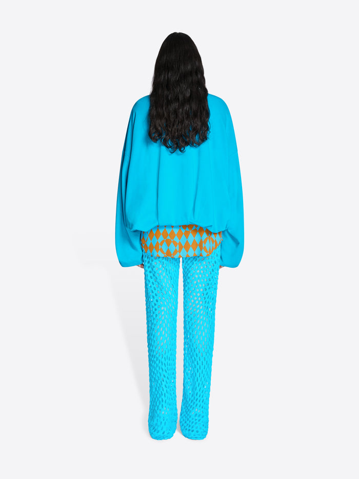 Person wearing a blue outfit with a patterned design on a white background - Dries Van Noten