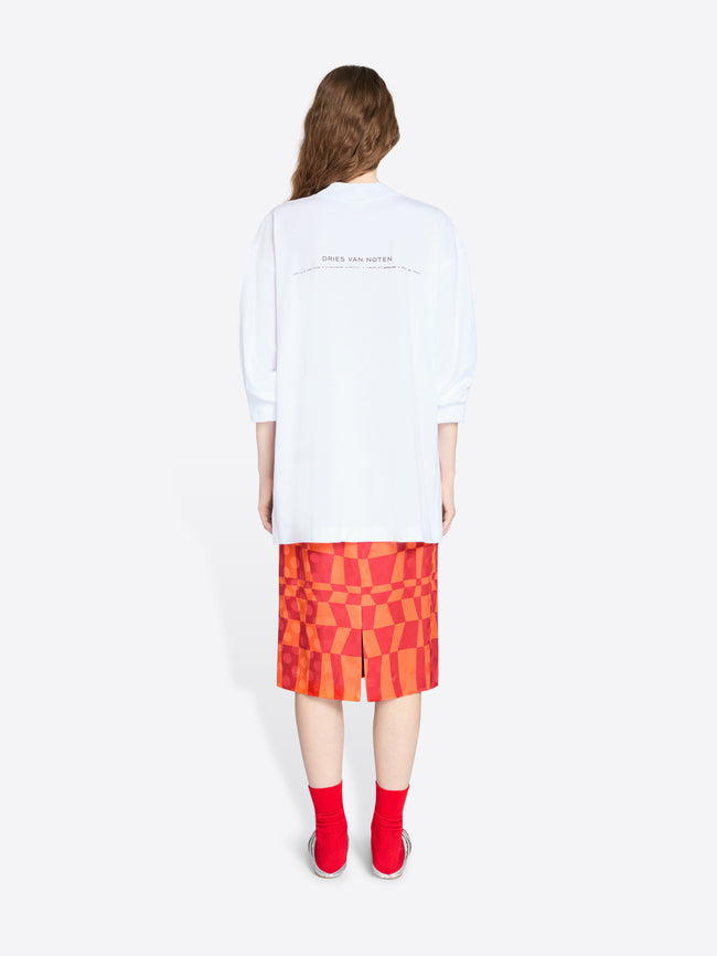 Person wearing a white t-shirt and a red checkered skirt on a white background - Dries Van Noten