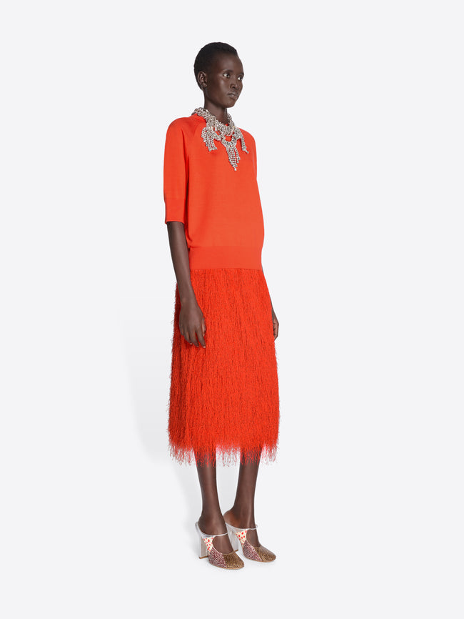 Woman wearing an orange outfit with a white background - Dries Van Noten