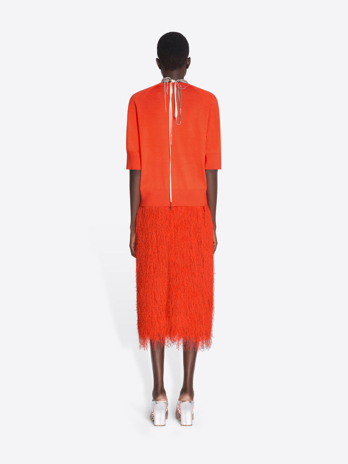 Person wearing an orange outfit with a white background - Dries Van Noten