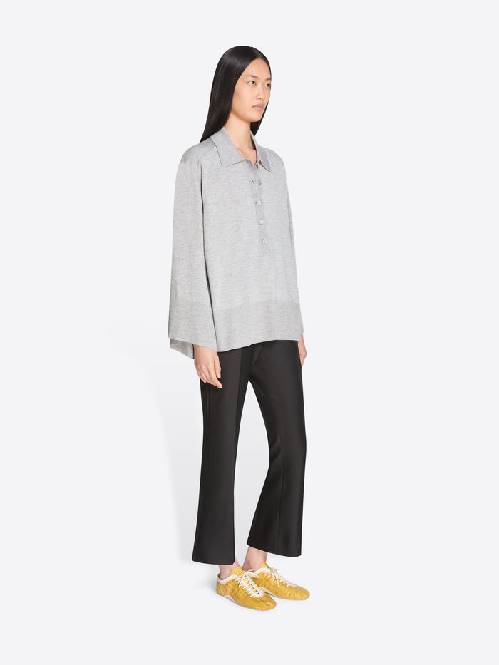 Woman wearing a light gray shirt and black pants on a white background - Dries Van Noten