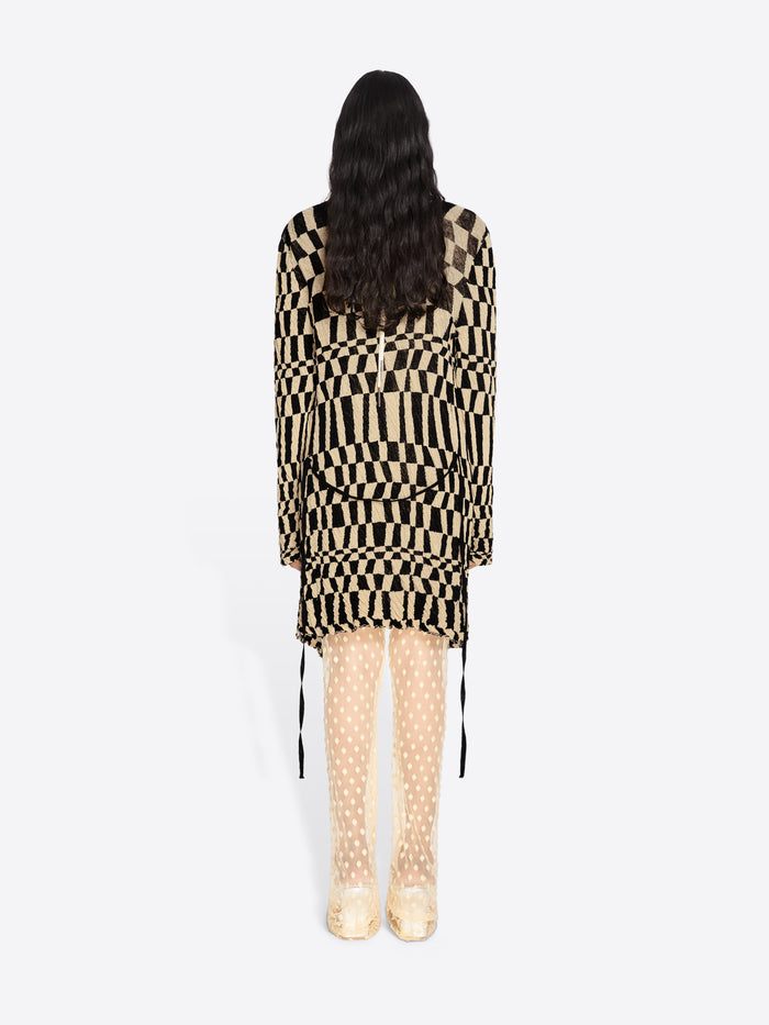 Person wearing a black and beige checkered outfit on a white background - Dries Van Noten