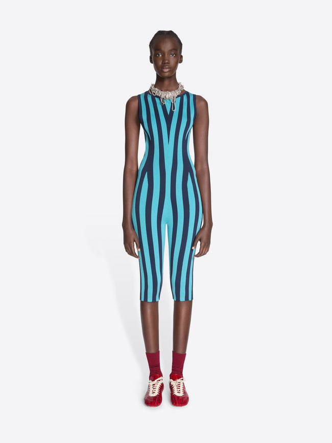 Model wearing a blue and black striped jumpsuit on a white background - Dries Van Noten